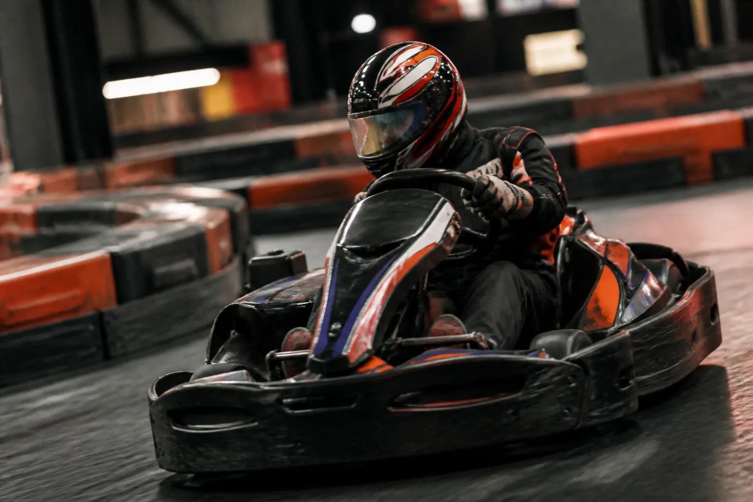 Competitive indoor kart driver at Apex Karting chasing lap time