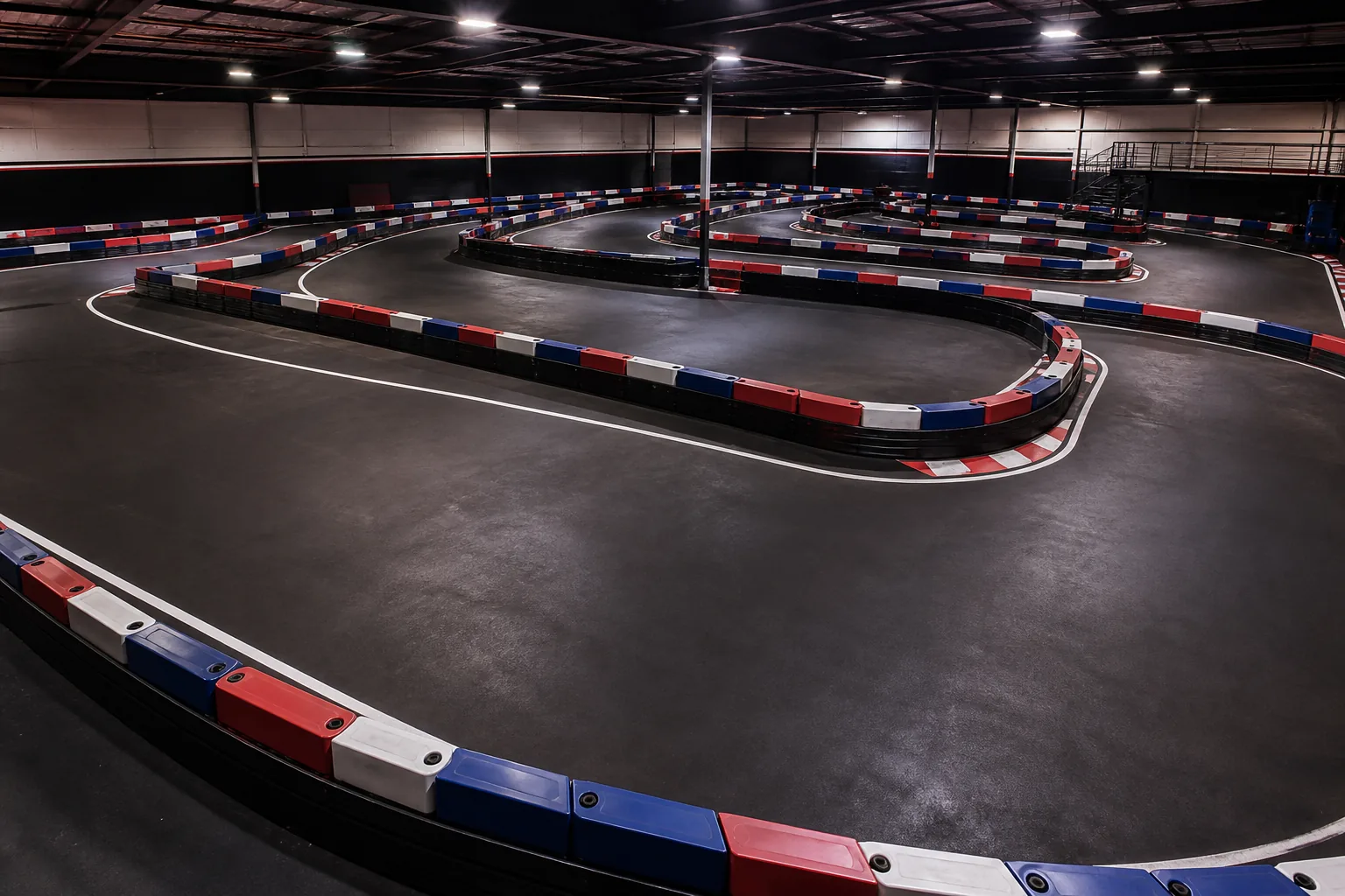Apex Karting indoor circuit under race lighting in Bushton