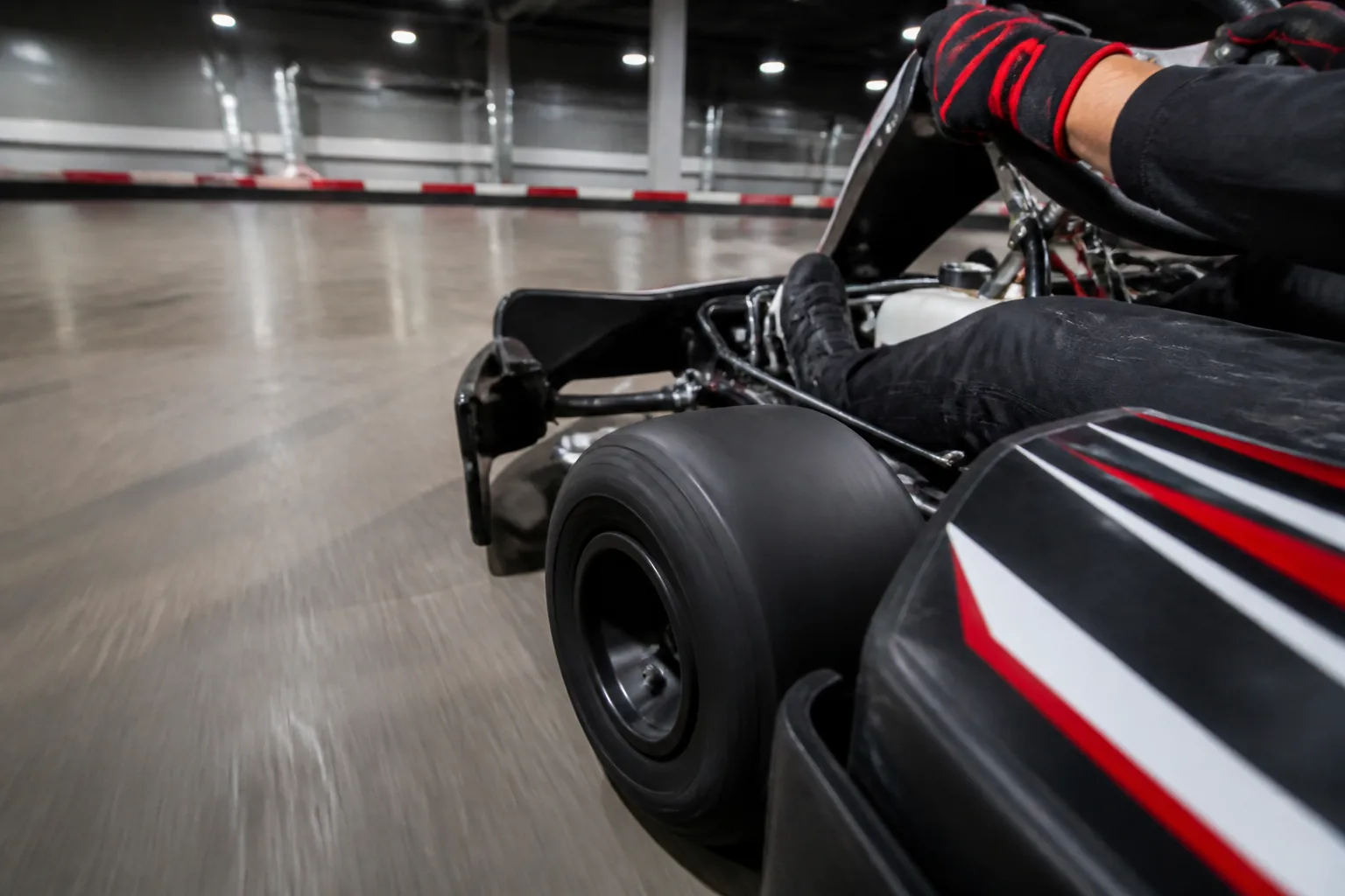 Apex Karting driver gripping the wheel on the indoor circuit